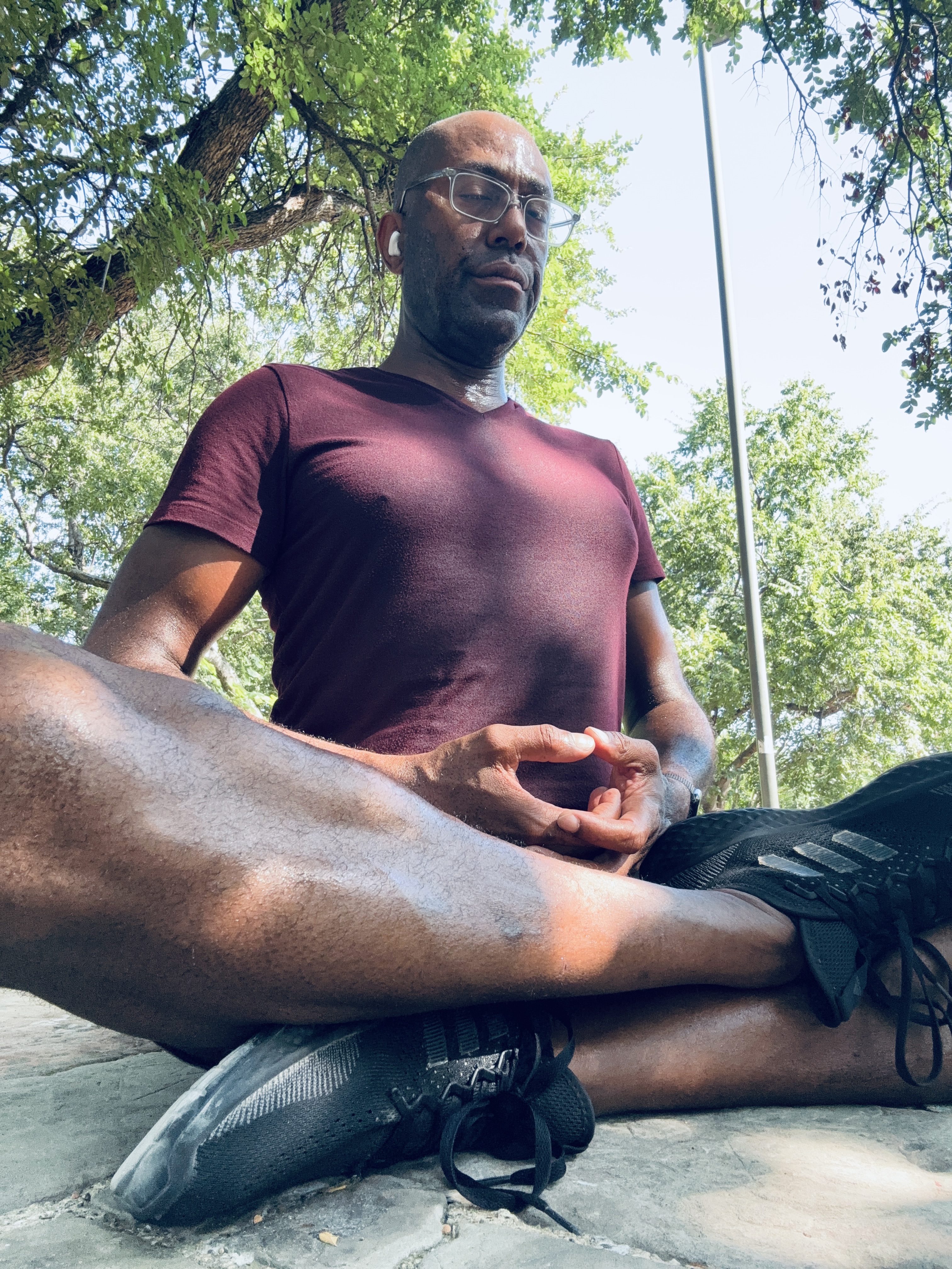 Louis Hill Jr. leading outdoor park yoga